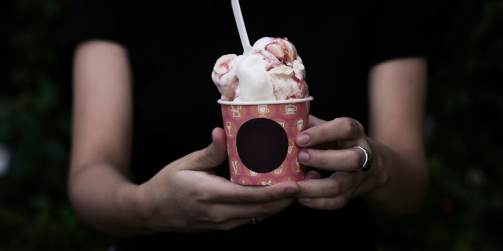 person holding bucket of ice cream